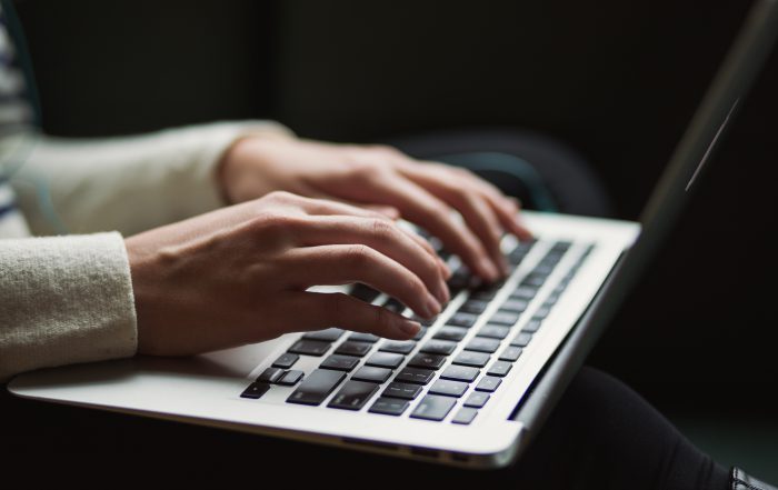 woman on laptop - cyber bullying